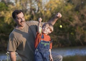 dad and young son fishing med
