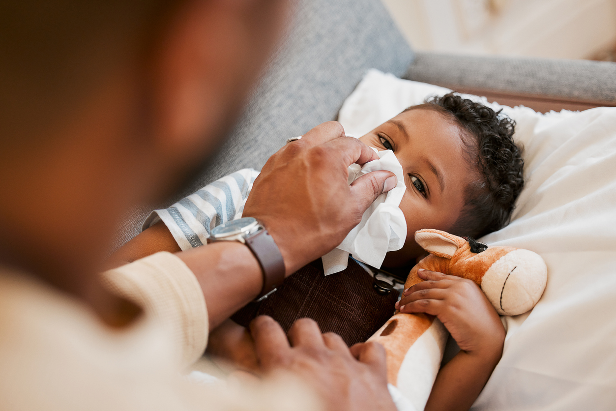 illness prevention in childcare. Sick child being cared for by caregiver.