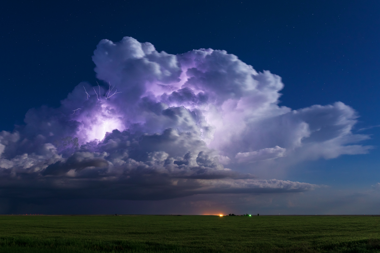 Preparing for Severe Weather Dramatic thunderstorm cumulonimbus cloud with lightning over a field in Kansas. Weather and climate concept.